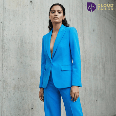"A confident woman posing in a tailored electric blue suit, exemplifying bold and modern Women's fashion."